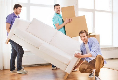Moving team using safe lifting practices during a relocation