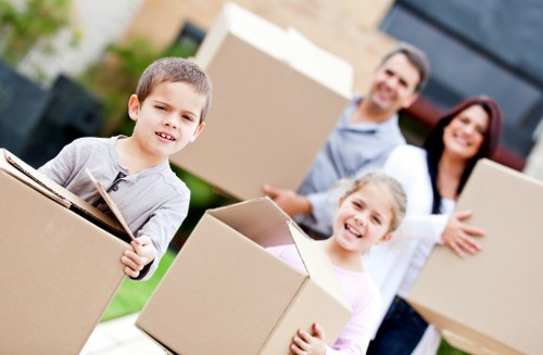 Local movers carrying furniture during a Ruislip house relocation
